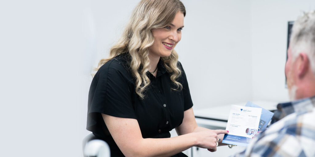 staff member going over finance paper with Patient